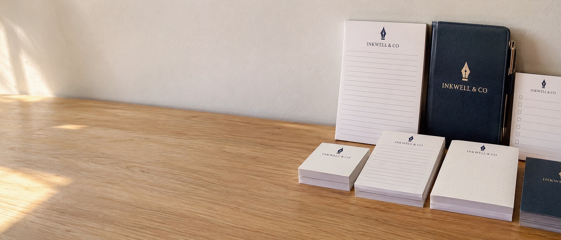 Custom printed notepads in bulk stacked on an office desk